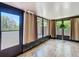Enclosed sunroom with large windows and curtains at 12110 Palmetto Ct, Dunnellon, FL 34432
