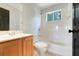 Bathroom features a tub and shower combination, a window and a wooden vanity at 12346 Lake Valley Dr, Clermont, FL 34711