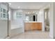 Bright bathroom features a soaking tub, double vanity, and tile flooring at 12346 Lake Valley Dr, Clermont, FL 34711
