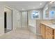 A bright bathroom with a walk-in shower, soaking tub and wooden vanity at 12346 Lake Valley Dr, Clermont, FL 34711