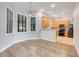 Dining area with gray flooring, large windows with wood blinds, and a view to the kitchen at 12346 Lake Valley Dr, Clermont, FL 34711