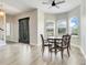 Well-lit dining area featuring hardwood floors, a bay window, and seamless flow into the entryway and adjacent rooms at 12346 Lake Valley Dr, Clermont, FL 34711