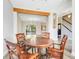 Dining room view, hardwood floors, highlighting the open layout to the living area with natural light and beams at 12346 Lake Valley Dr, Clermont, FL 34711