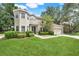 Inviting two-story home with well-maintained landscaping and a classic exterior design, nestled among lush trees at 12346 Lake Valley Dr, Clermont, FL 34711