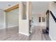 Open foyer boasts gray flooring, decorative columns, and a staircase with dark wood accents at 12346 Lake Valley Dr, Clermont, FL 34711