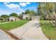 Charming home with a well-manicured lawn, mature trees, and a spacious driveway leading to a multi car garage at 12346 Lake Valley Dr, Clermont, FL 34711