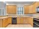 Bright kitchen with wood cabinets, tile flooring, stainless steel appliances, and a double oven at 12346 Lake Valley Dr, Clermont, FL 34711