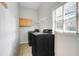 Bright laundry room features a modern washer and dryer, plus cabinet storage, and a window for natural light at 12346 Lake Valley Dr, Clermont, FL 34711