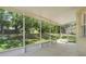 View of the screened-in porch and landscaped backyard at 12346 Lake Valley Dr, Clermont, FL 34711