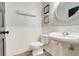 A powder room featuring a pedestal sink, beadboard wall and decorative accents at 12346 Lake Valley Dr, Clermont, FL 34711