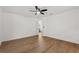 Bright bedroom features wood floors, ceiling fan, neutral walls, and a doorway to the bathroom at 1415 S Baton Dr, Deltona, FL 32725