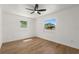 Bright bedroom with wood floors, two windows, and a ceiling fan providing comfort and natural light at 1415 S Baton Dr, Deltona, FL 32725