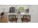 Modern kitchen with stainless steel appliances, granite countertops, and bar stool seating at the island at 1415 S Baton Dr, Deltona, FL 32725