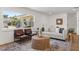 Well-lit living area boasting hardwood floors, a comfortable seating arrangement, and inviting decor at 1415 S Baton Dr, Deltona, FL 32725