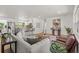 Open-concept living area showcasing stylish furniture, hardwood floors, and seamless flow to the modern kitchen at 1415 S Baton Dr, Deltona, FL 32725