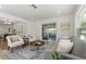 Spacious living area with hardwood floors, comfortable seating, and a sliding glass door at 1415 S Baton Dr, Deltona, FL 32725