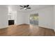 Spacious main bedroom with wood floors, sliding doors, ceiling fan, and an en-suite bathroom, offering comfort and convenience at 1415 S Baton Dr, Deltona, FL 32725