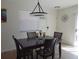 Charming dining area featuring a chandelier and seating for four guests at 1420 Fairway St, The Villages, FL 32162