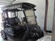 View of the golf cart parked in the garage featuring the Yamaha Drive logo and two seats at 1420 Fairway St, The Villages, FL 32162