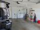Spacious garage with a golf cart, washer and dryer, storage shelves, and white door to interior at 1420 Fairway St, The Villages, FL 32162