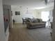 Bright living room with modern furniture, wood floors and open dining area at 1420 Fairway St, The Villages, FL 32162