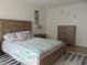 Comfortable bedroom with a wooden bed frame and a dresser at 1420 Fairway St, The Villages, FL 32162