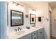 Bright bathroom with double sinks, large mirrors, and modern lighting fixtures at 1422 Jeremy Cir, The Villages, FL 34762