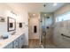 Modern bathroom with a glass-enclosed shower, dual vanities, and contemporary fixtures at 1422 Jeremy Cir, The Villages, FL 34762