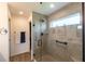 Walk-in shower with glass door, and tile surround, and storage shelves at 1422 Jeremy Cir, The Villages, FL 34762