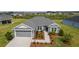 Charming single-story home showcasing well-manicured landscaping and an inviting front entrance at 1422 Jeremy Cir, The Villages, FL 34762