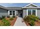 Inviting walkway leading to the front door, surrounded by lush landscaping and blooming flowers at 1422 Jeremy Cir, The Villages, FL 34762