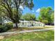 Cozy one-story home with lush green lawn, mature trees, and a welcoming front entrance at 14536 Sw 34Th Terrace Rd, Ocala, FL 34473