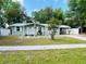 Charming single-story home showcasing a well-manicured lawn and a welcoming front porch at 14536 Sw 34Th Terrace Rd, Ocala, FL 34473