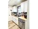 Bright kitchen featuring white cabinetry, stainless steel appliances, and stylish backsplash at 14536 Sw 34Th Terrace Rd, Ocala, FL 34473