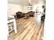 Open-concept living room featuring elegant sofas, wood-look floors, and abundant natural light at 14536 Sw 34Th Terrace Rd, Ocala, FL 34473