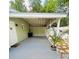 Spacious covered patio area ideal for outdoor living and entertaining, with mature trees and plants at 14536 Sw 34Th Terrace Rd, Ocala, FL 34473