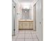 Bathroom vanity area featuring storage cabinets and a mirror with lighting fixtures at 15918 Summit Ct, Clermont, FL 34711