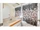 Bathroom with decorative shower curtain, vanity, and bright lighting at 15918 Summit Ct, Clermont, FL 34711