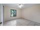 Bedroom with tiled floor, ceiling fan and a window offering views of the surrounding area at 15918 Summit Ct, Clermont, FL 34711
