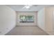 Carpeted bedroom with ceiling fan and a large window providing natural light at 15918 Summit Ct, Clermont, FL 34711