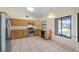 Bright kitchen featuring stainless steel appliances, ample cabinet space, and tile flooring at 15918 Summit Ct, Clermont, FL 34711