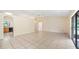 Bright, open living room featuring tile floors and sliding glass doors to the outside at 15918 Summit Ct, Clermont, FL 34711