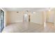 Open-plan living room showcasing tile flooring, ceiling fan, and access to kitchen and front entryway at 15918 Summit Ct, Clermont, FL 34711