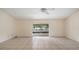 Large living room featuring tile floors and sliding glass doors to the screened in patio at 15918 Summit Ct, Clermont, FL 34711