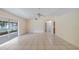 Spacious living room with tile floor, ceiling fan and sliding door to the screened patio at 15918 Summit Ct, Clermont, FL 34711