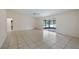 Spacious living room with tile floors and sliding glass doors leading to a screened-in patio at 15918 Summit Ct, Clermont, FL 34711
