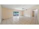 Bright living room with tile flooring, ceiling fan and access to the lanai at 15918 Summit Ct, Clermont, FL 34711