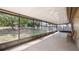 Enclosed screened patio with backyard views, and seating area at 15918 Summit Ct, Clermont, FL 34711