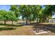 Scenic picnic area overlooking the lake, surrounded by mature trees and lush landscaping providing serene outdoor relaxation at 15918 Summit Ct, Clermont, FL 34711
