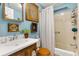 Charming bathroom features a wood vanity with sink, toilet and bathtub/shower with ornate decor at 1639 W Schwartz Blvd, The Villages, FL 32159